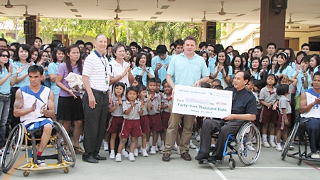 Brett Hayes, general manager for Thailand and Vietnam of Invida (Thailand) led his staff of 340 people to visit the Father Ray Foundation recently, where they received a warm welcome by the children under the care of the centre. They were treated to a game of wheelchair basketball played by handicapped students of the Redemptorist Vocational School. Mr. Hayes presented 45,000 baht to Udomchoke Choorat, director of the school. In addition Invida also sponsored foundation t-shirts valued at 8000 baht.